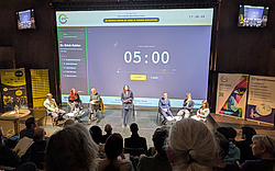The group debate on stage, discussing about to ban or not to ban AI in Higher Education.