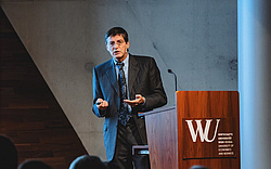 Kurt Hornik speaking at a lectern at WU Vienna.