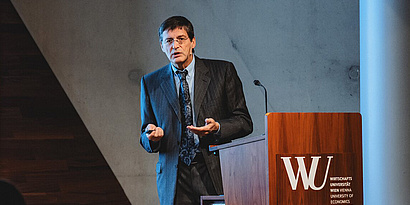 Kurt Hornik speaking at a lectern at WU Vienna.