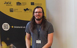 BilAI researcher Maximilian Heisinger sminling into the camera, in front of a Bilateral AI rollup.