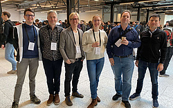 A group of researchers at the EURIPS conference, smiling in the camera,second from right is Christoph Lampert, BilAI key researcher.